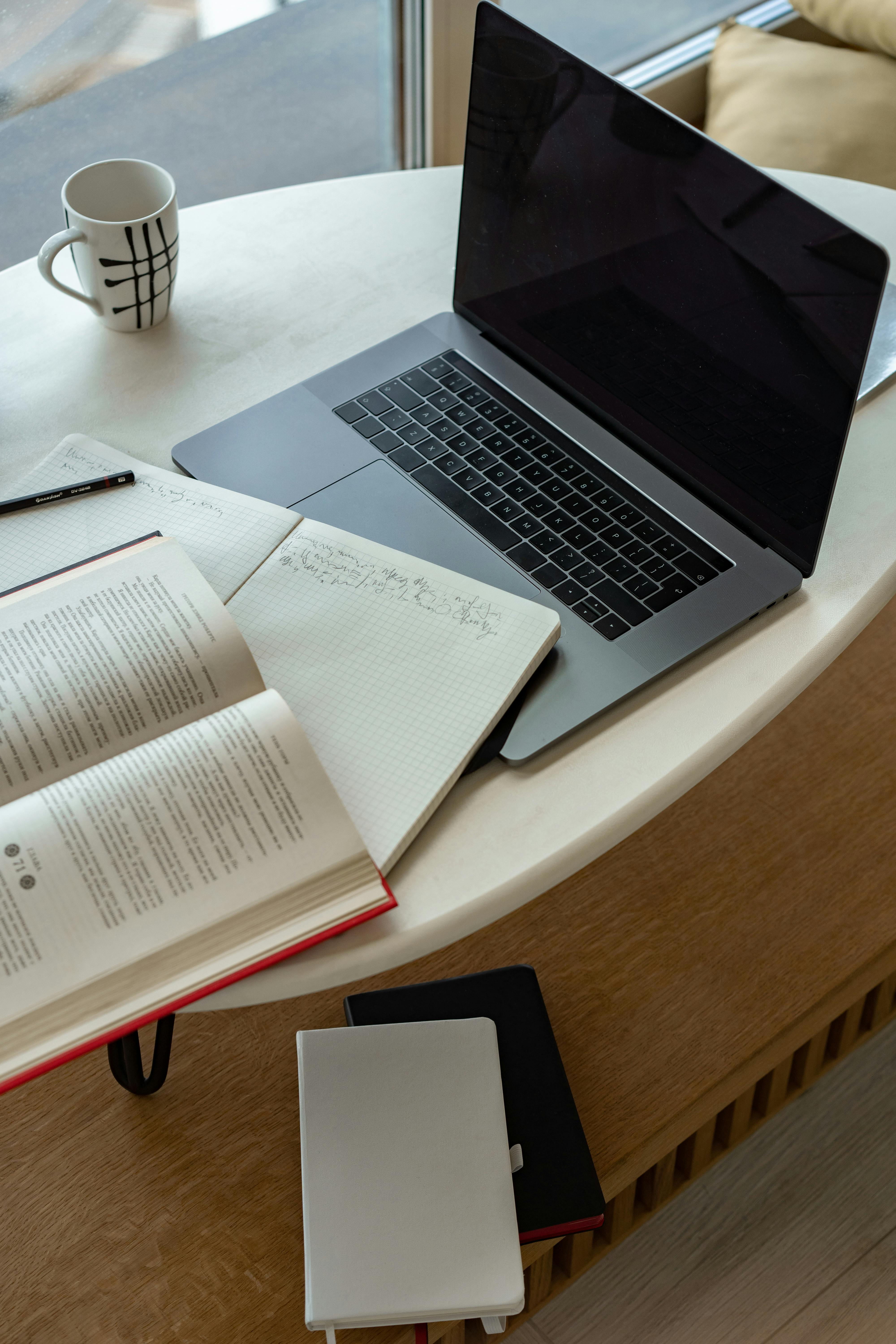 laptop and book on a table