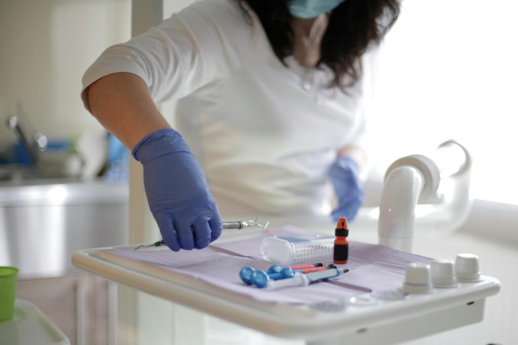 A nurse setting a tray for medical procedure