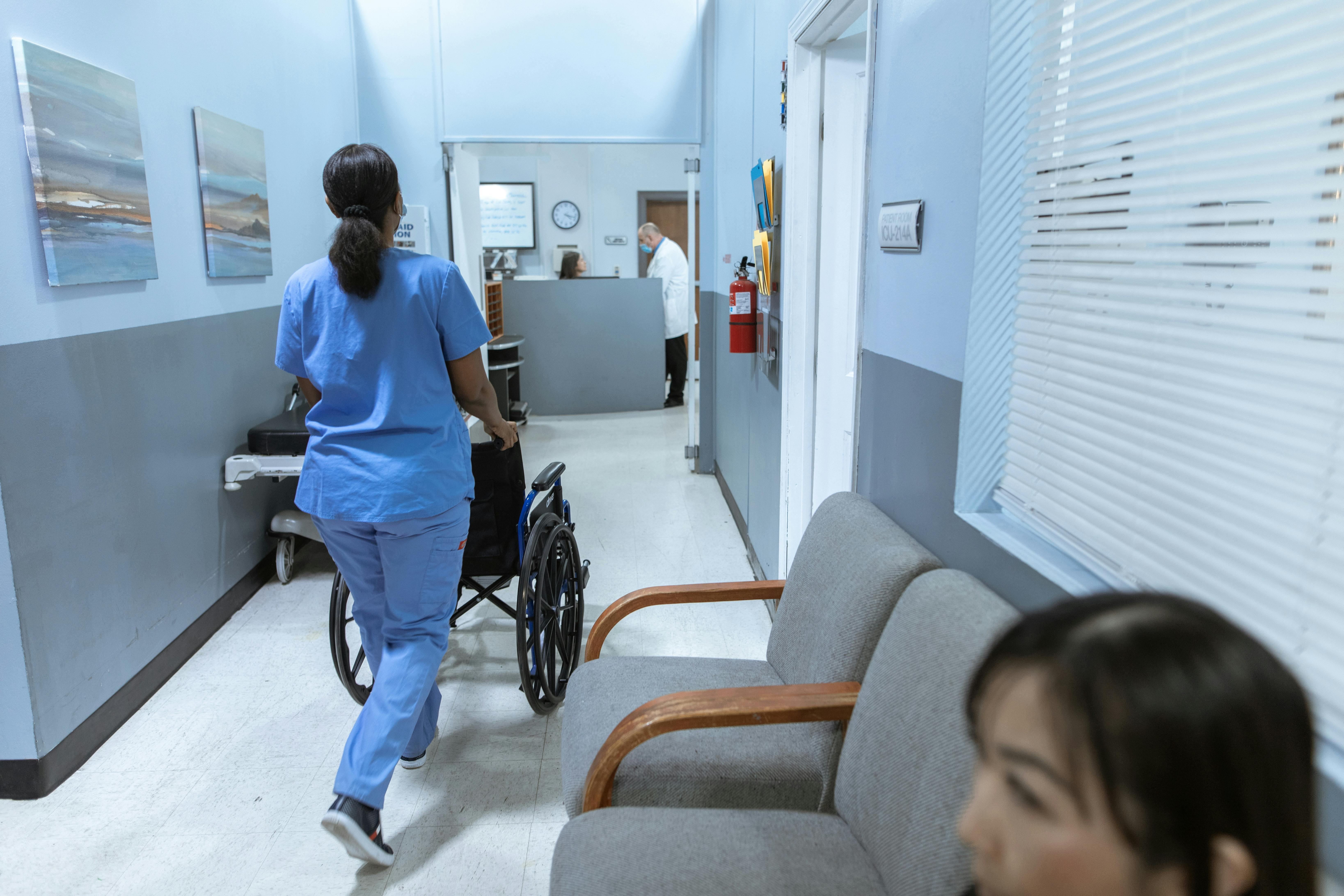 A Nurse pushing a wheel chair