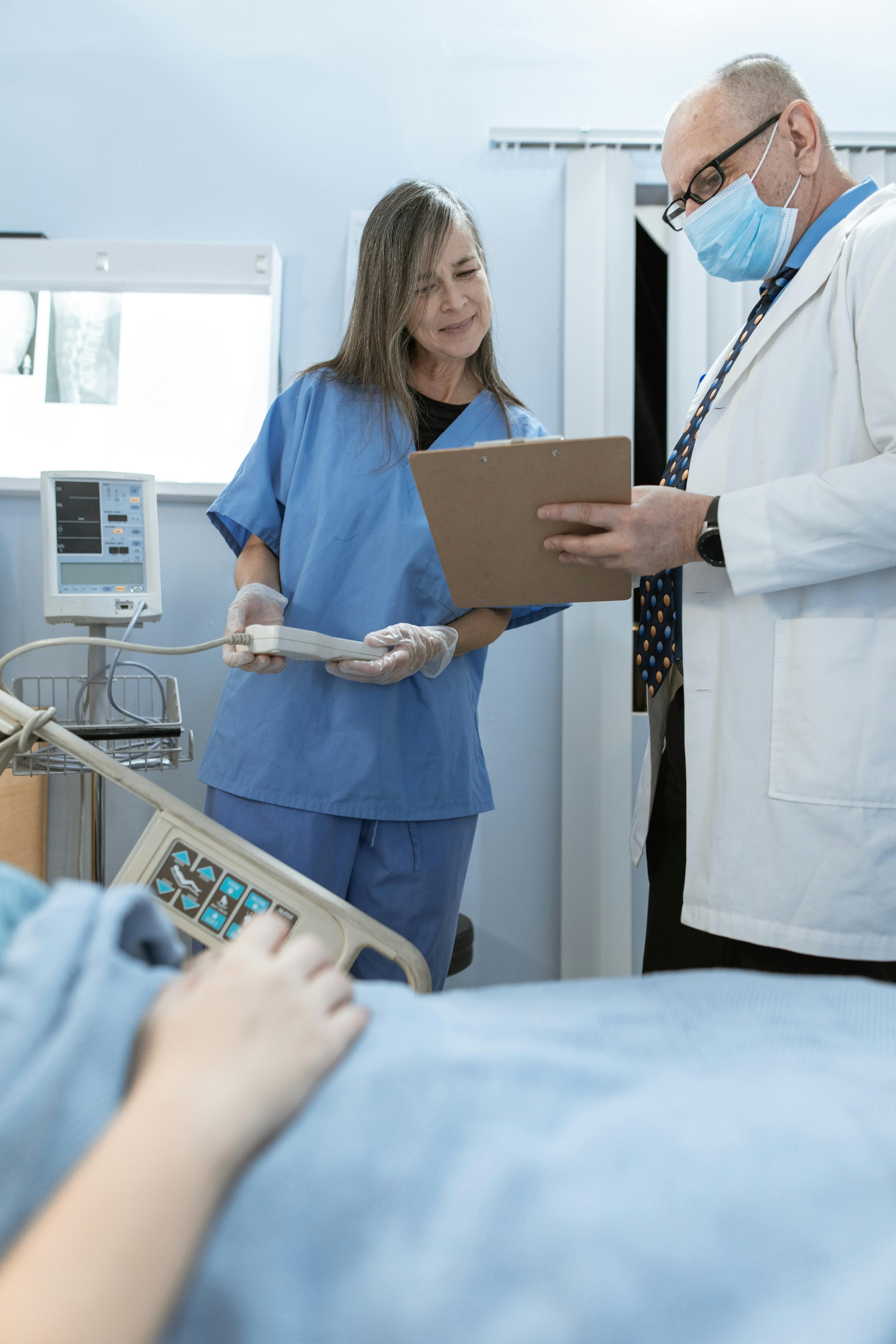 A nurse consulting with a doctor