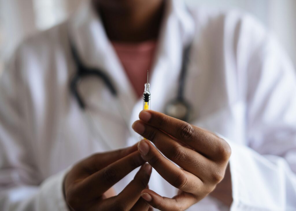 A doctor holding an injection