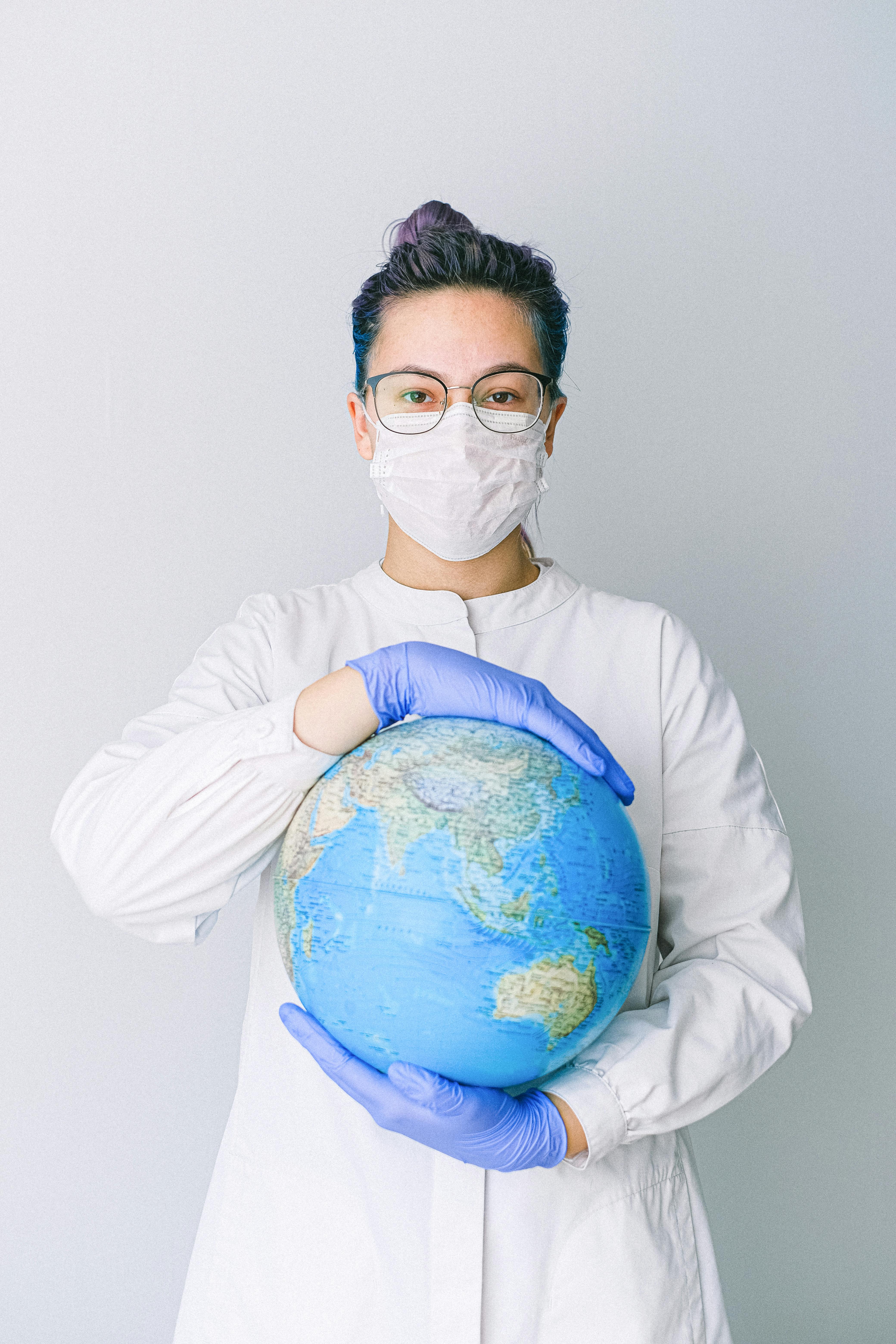 A nurse holding globe