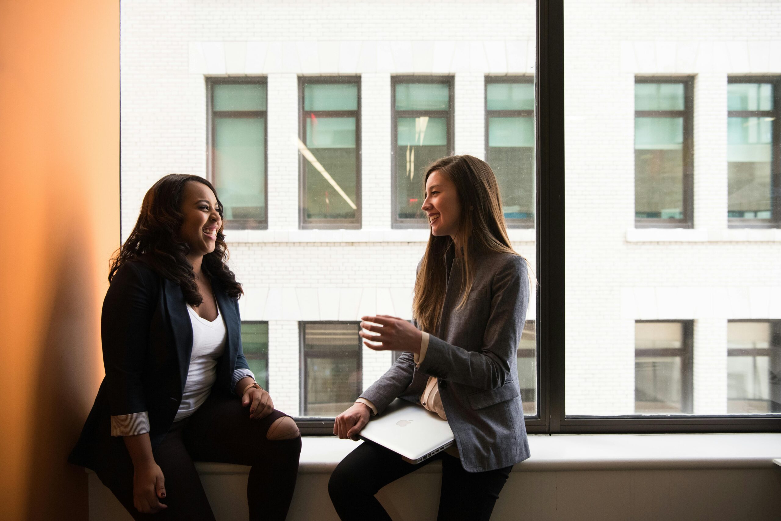 2 women sitting and networking