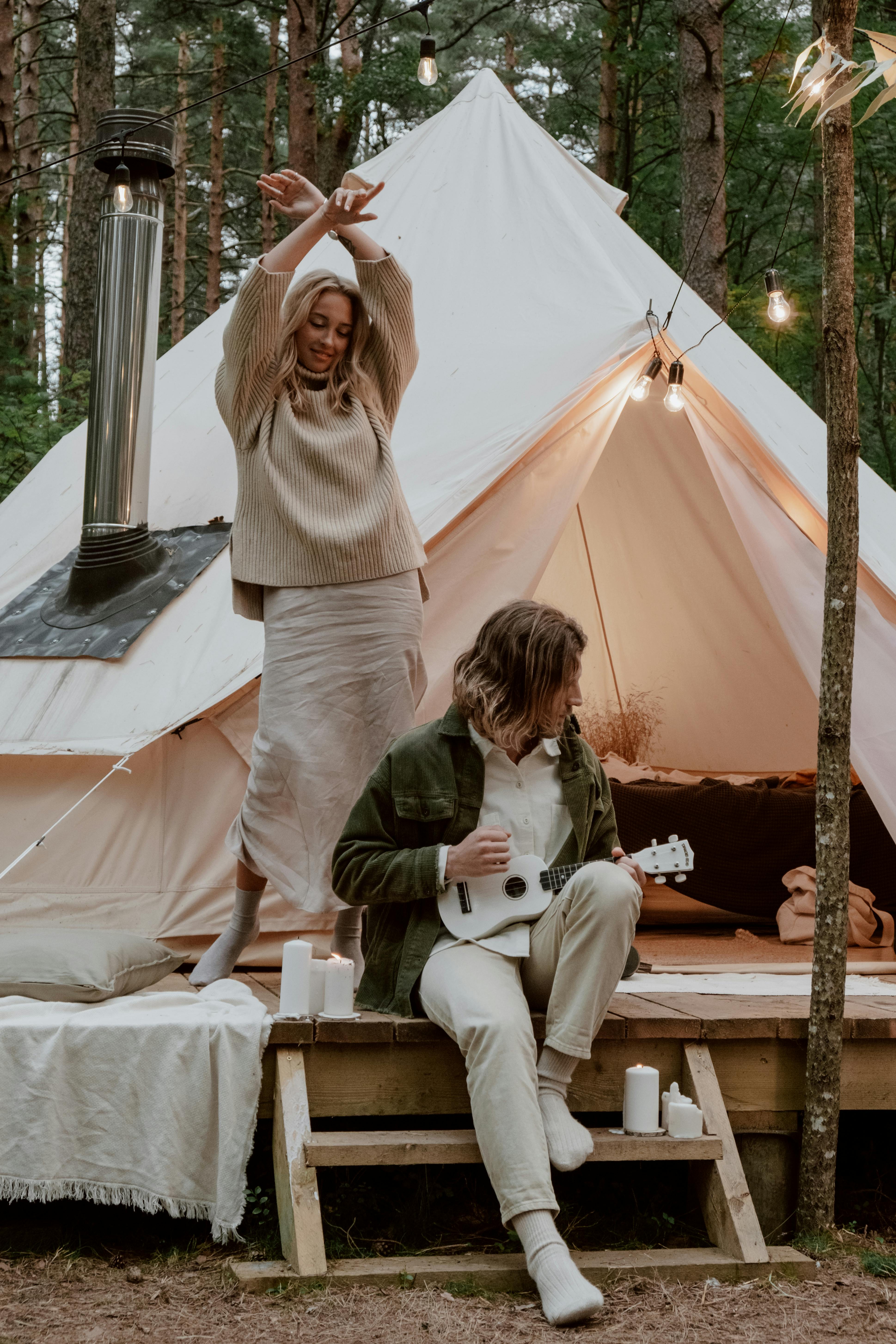 A COUPLE READING AT NIGHT ON CAMP