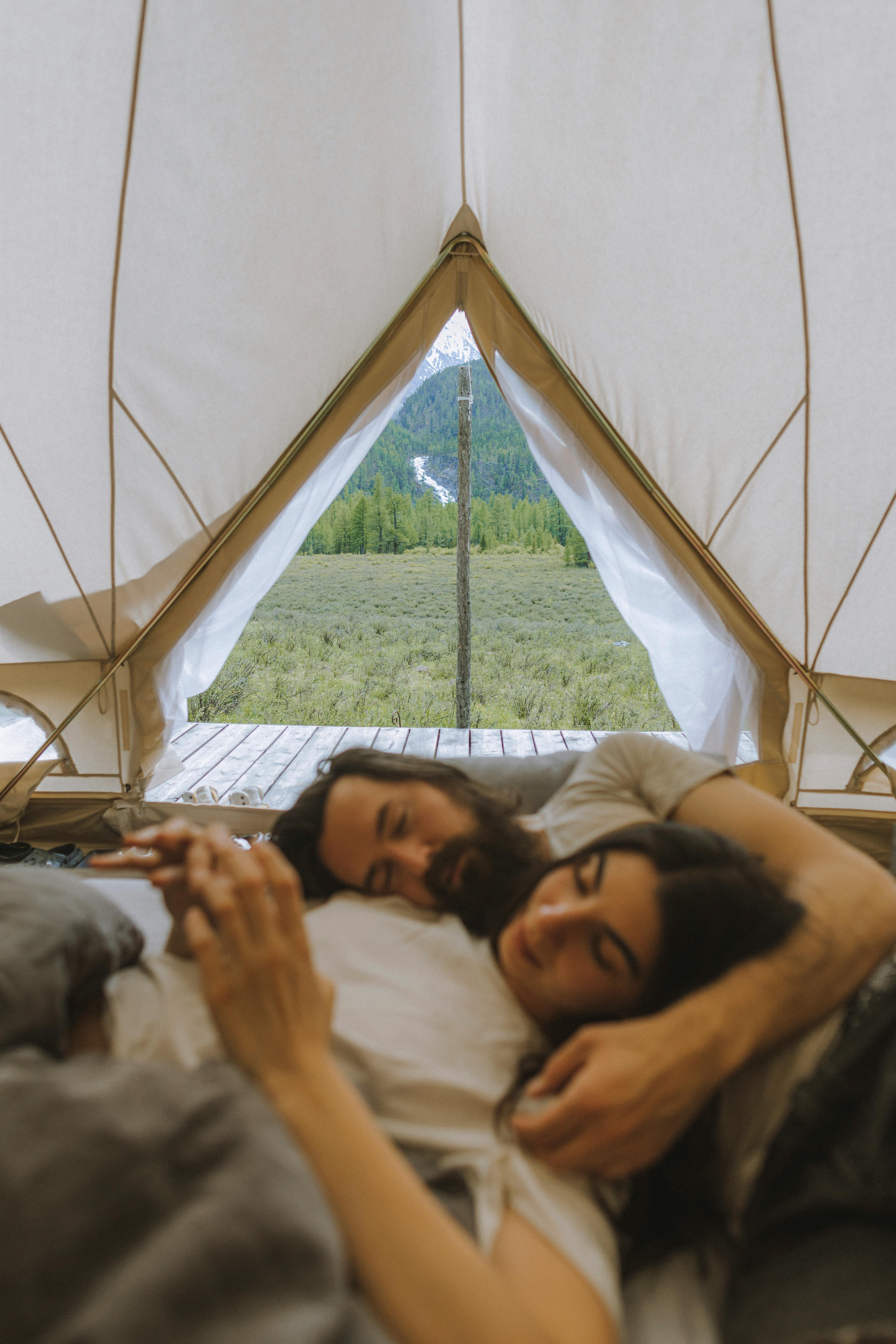 COUPLE SLEEPING IN THEIR TENT