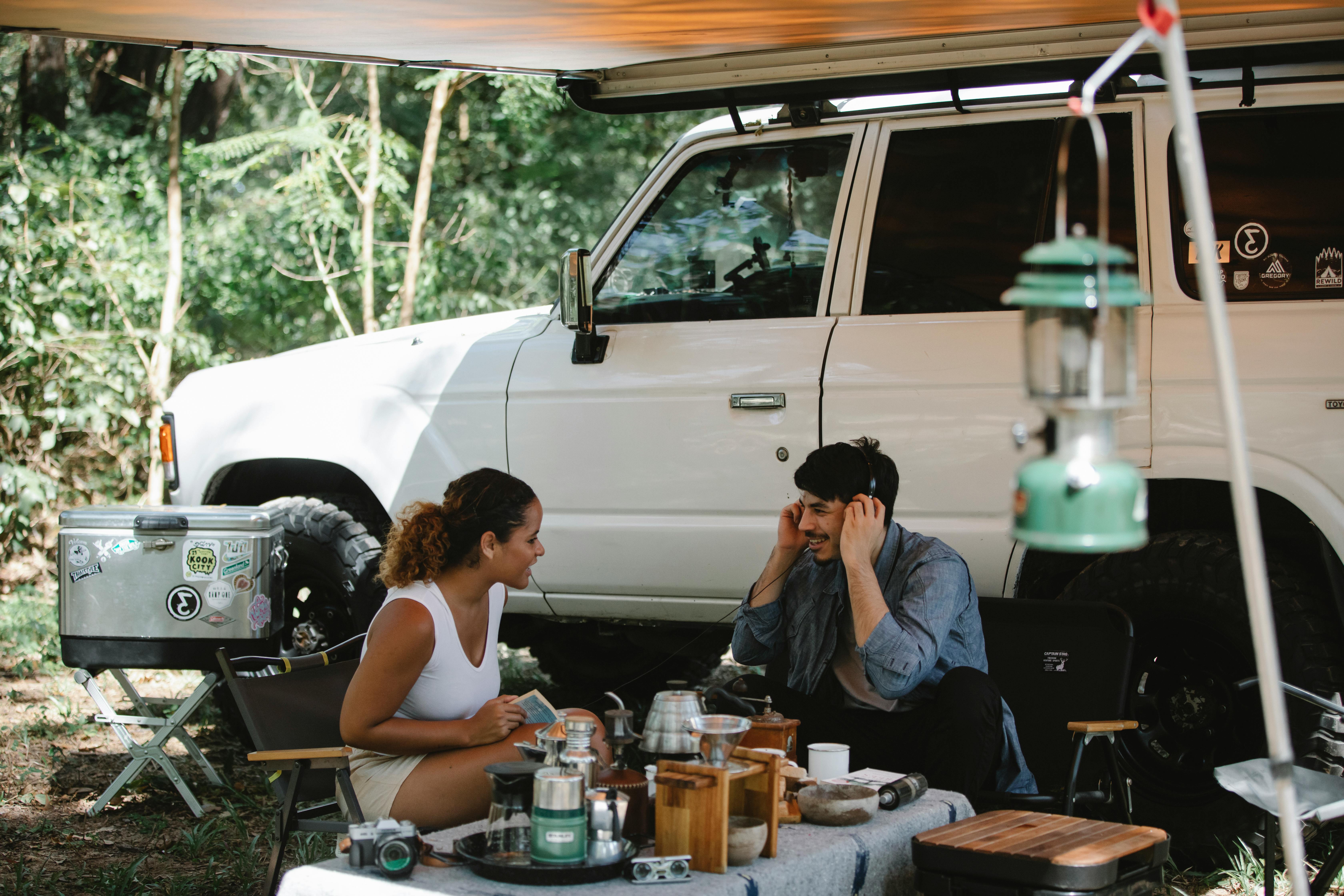 a couple conversing outside their van