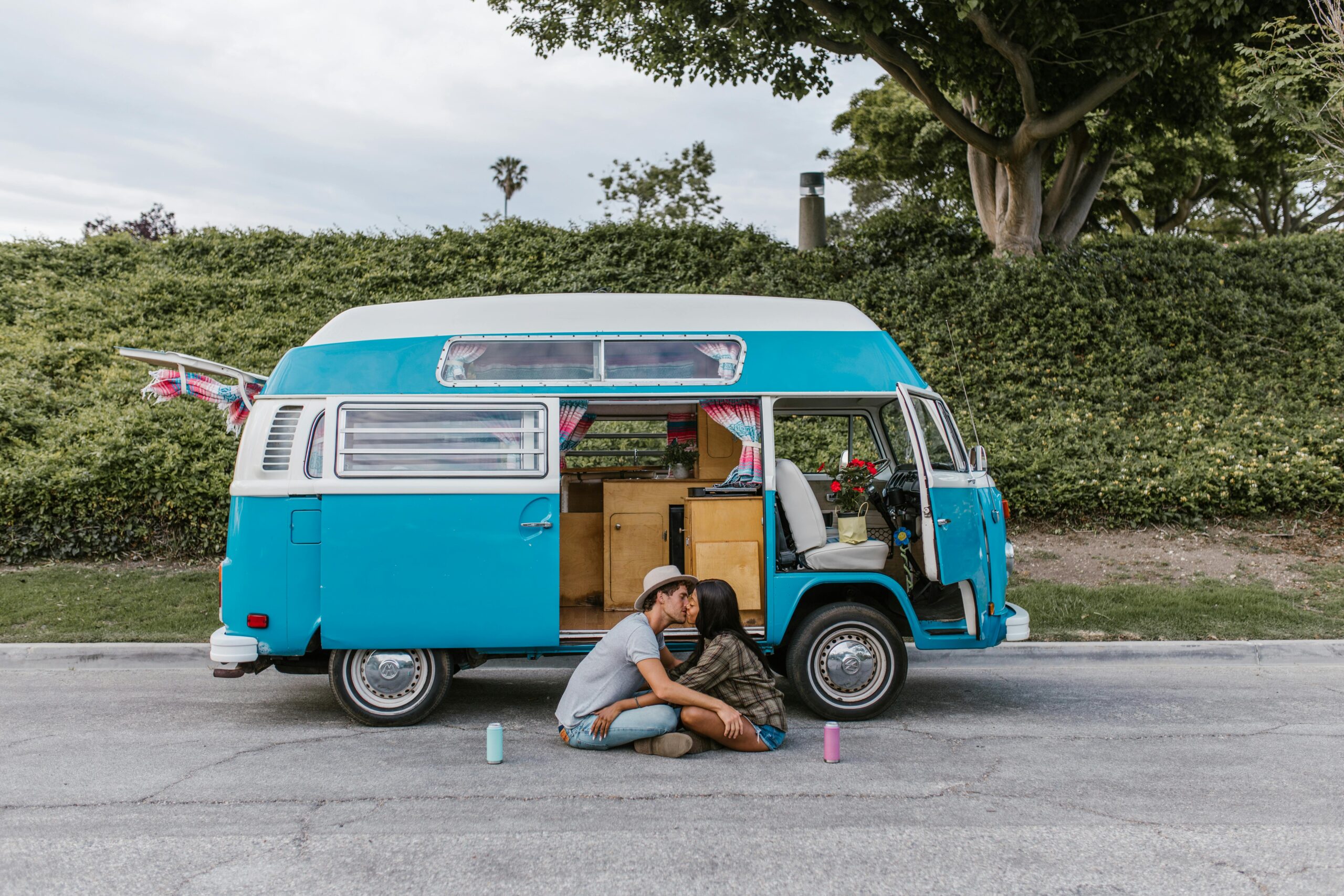 a couple sitting outside their van