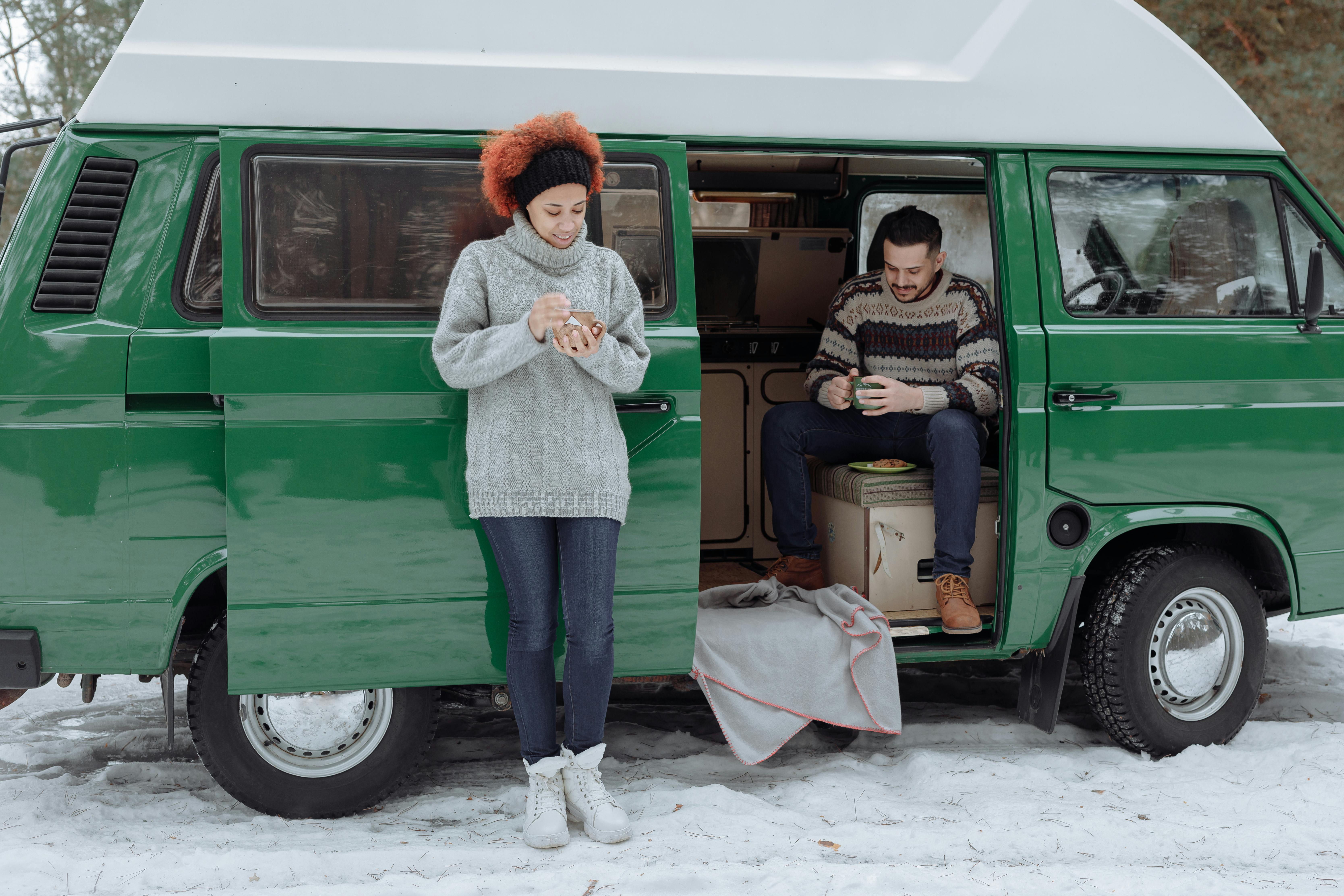 a couple outside their van in the winter