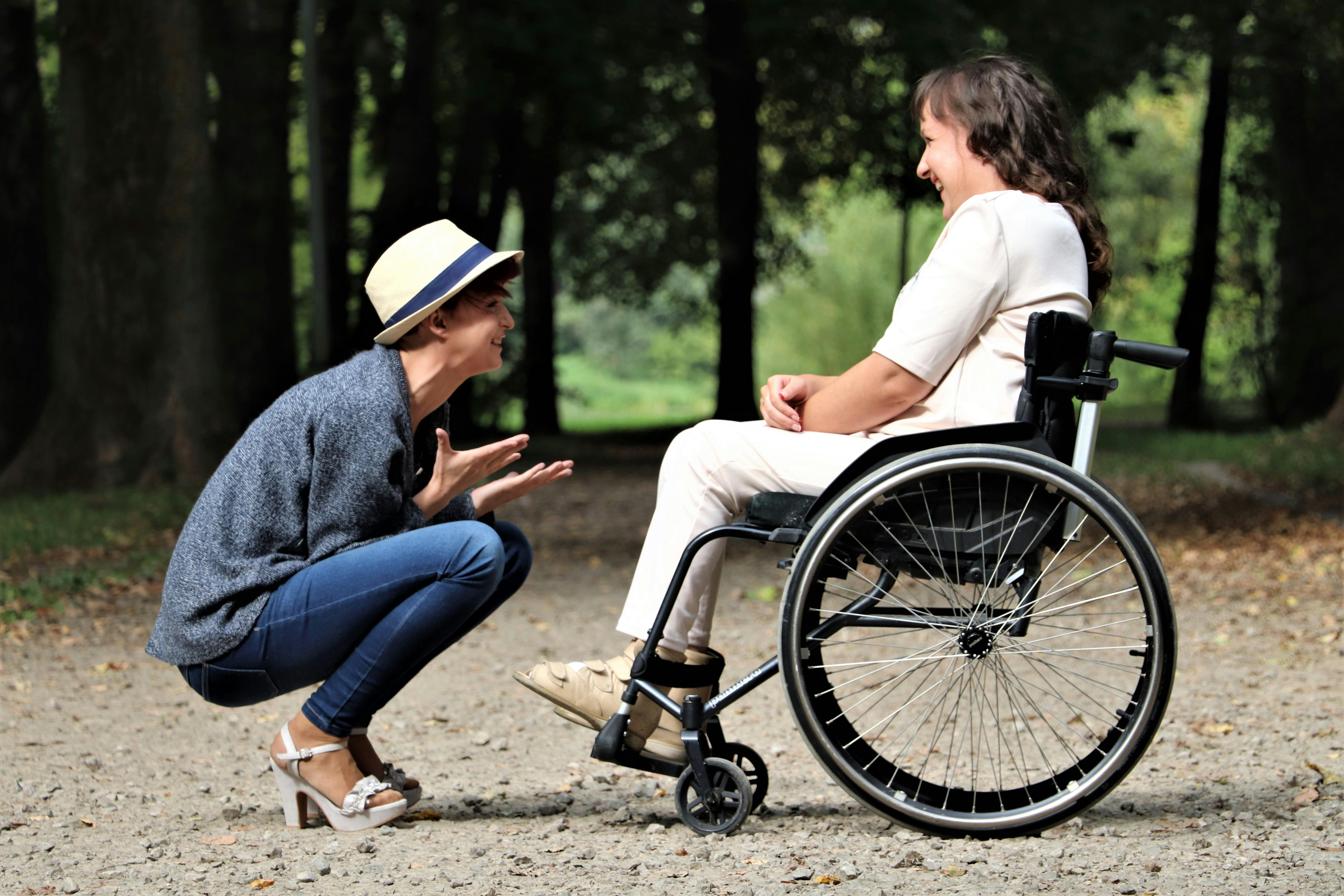 a couple with wheelchair out in the park