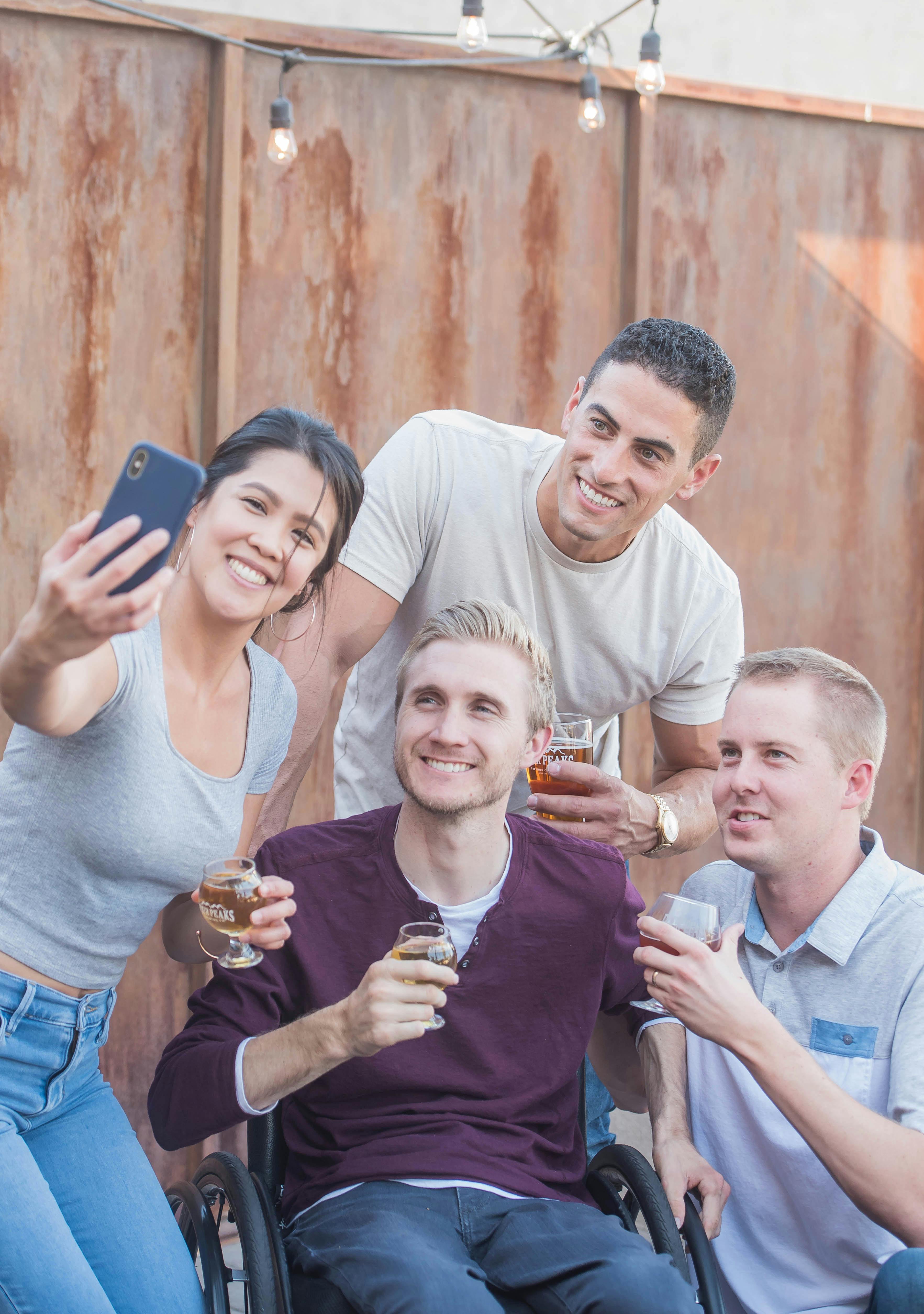 a man on wheelchair hanging out with his friends