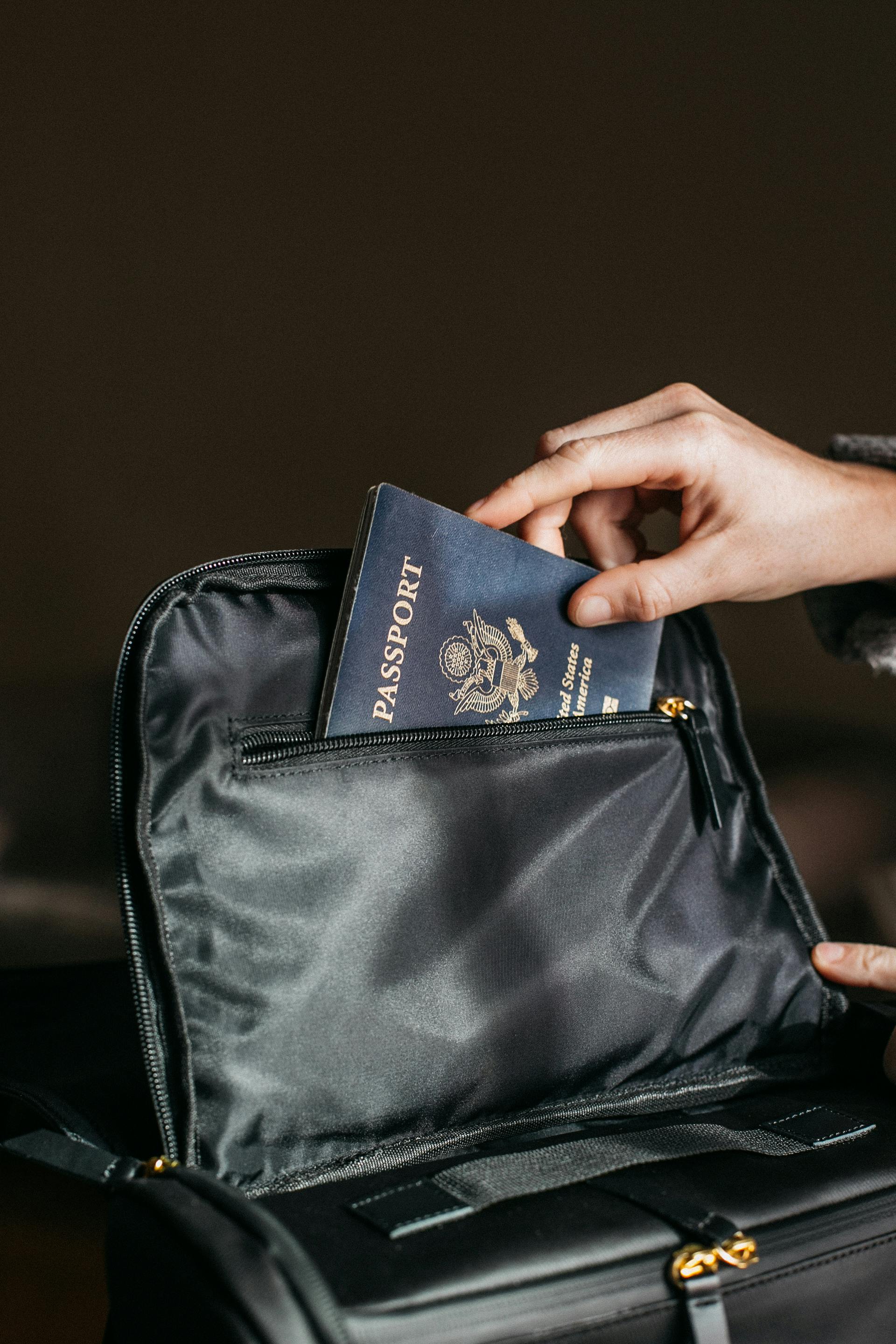 a man putting passports to the bag