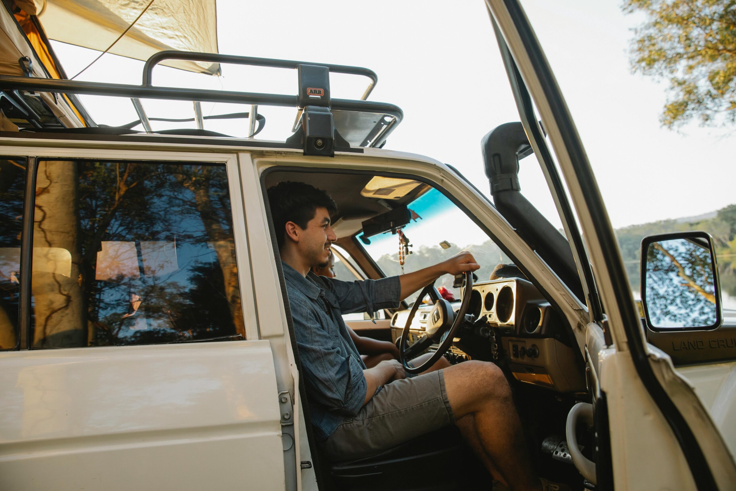 a man sitting in the driver seat of his van