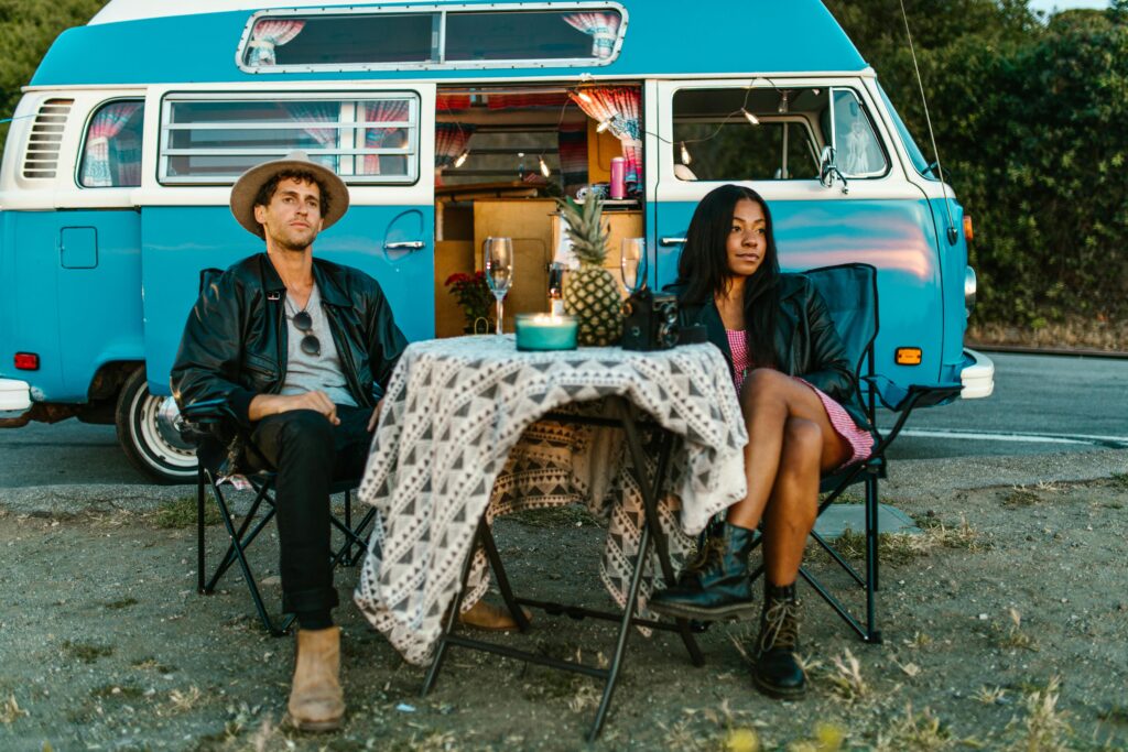 couple relaxing outside their van in the evening