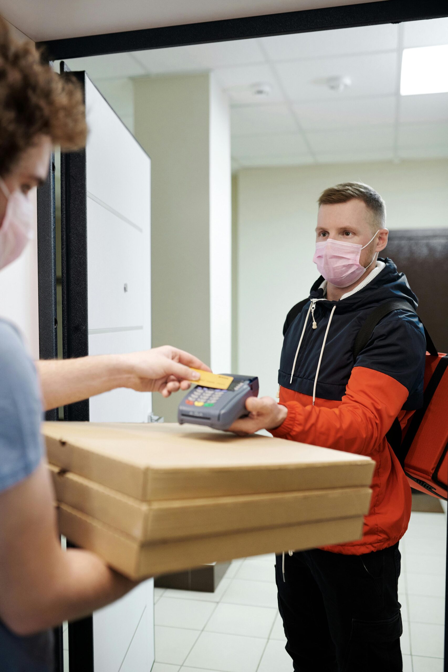 a man delivering food to a customer at home