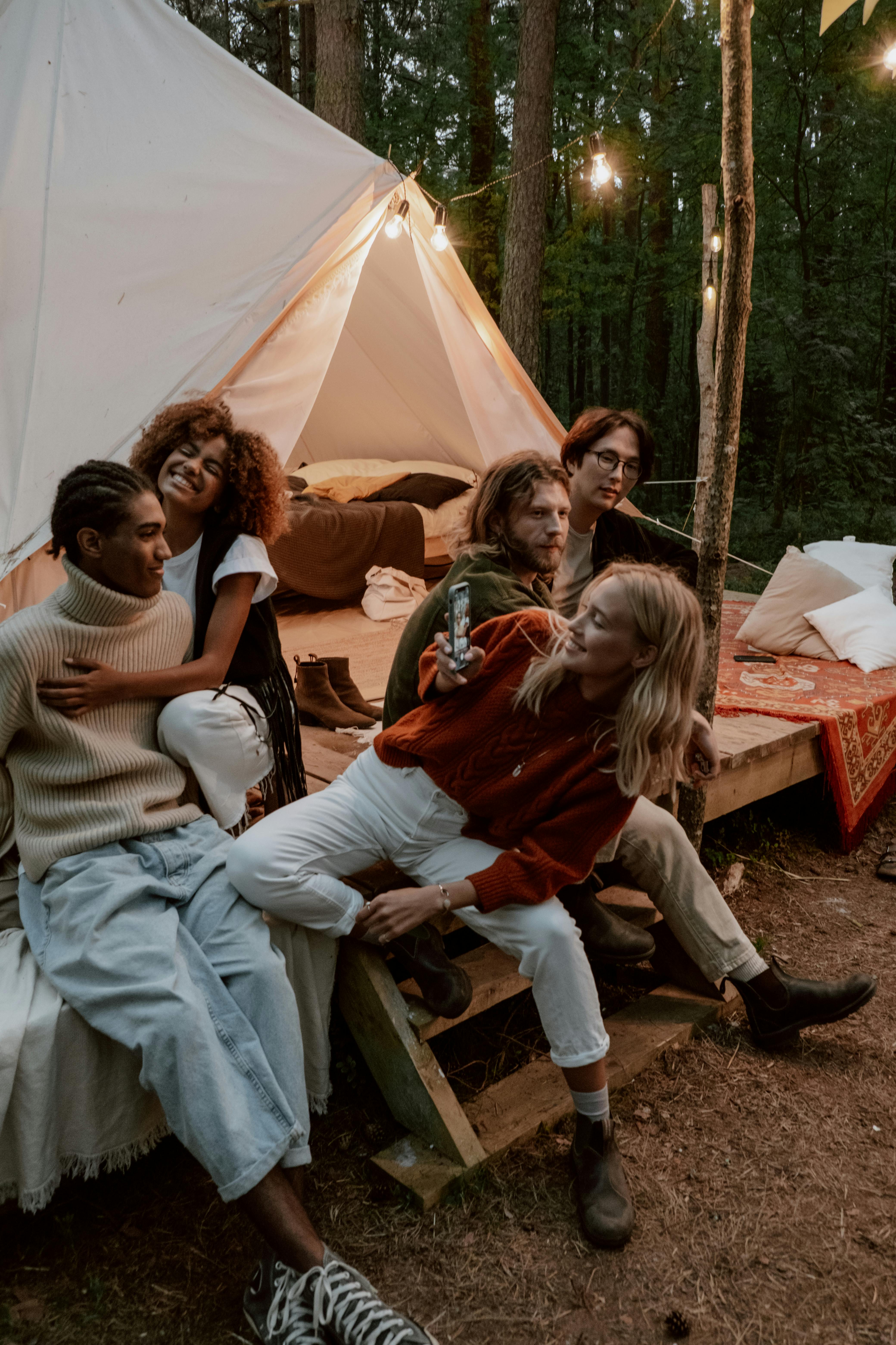 friends sitting around their camping tent