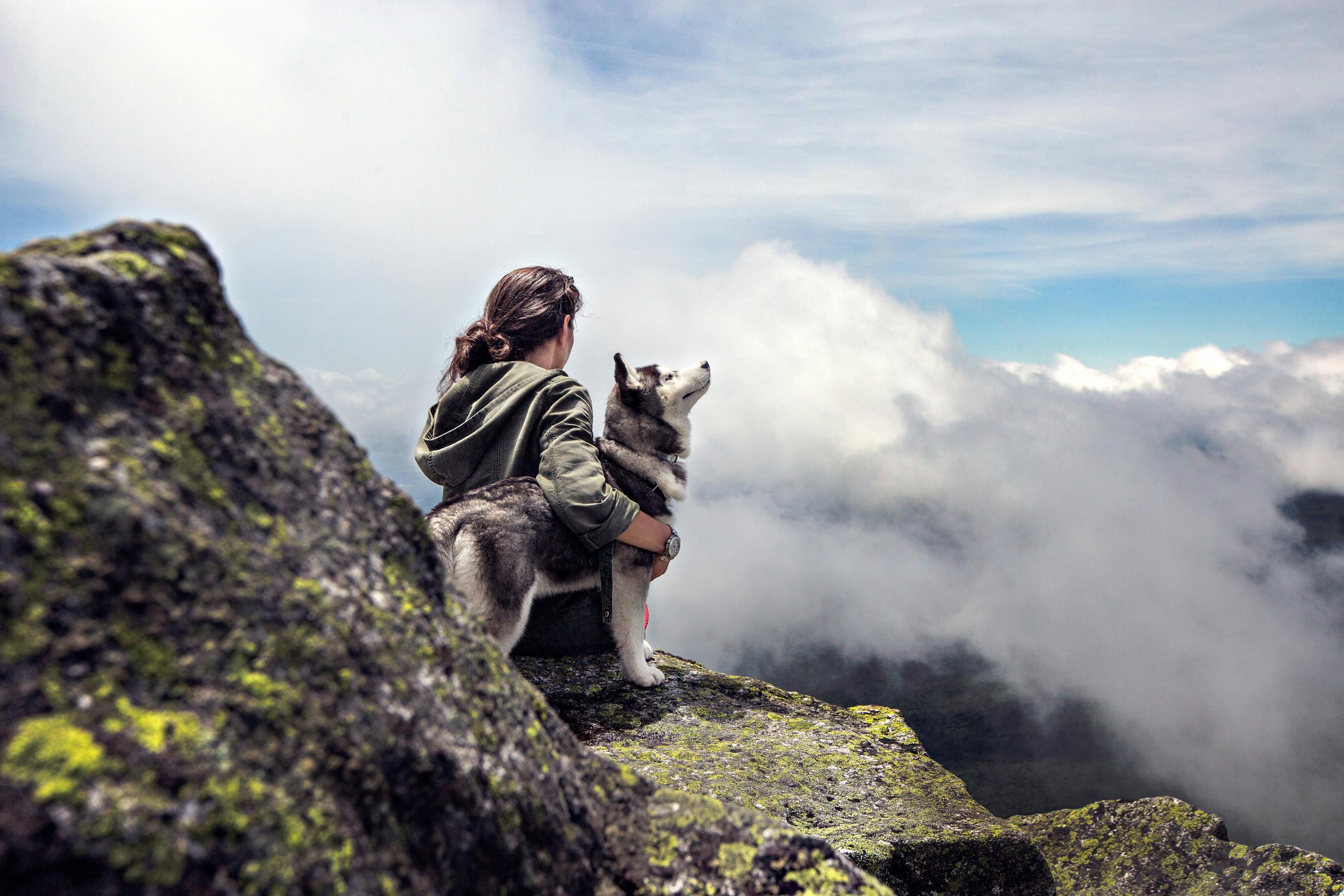 woman and her dog looking at the mountain