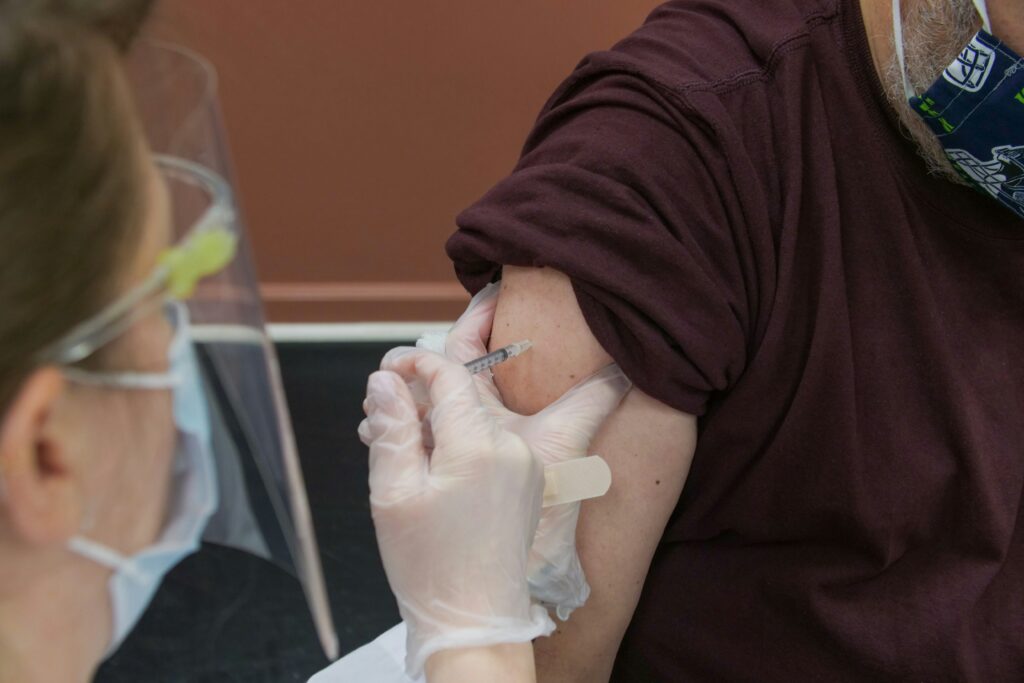 a man getting his vaccines