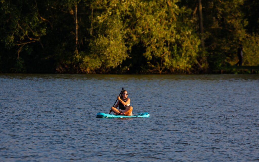 a lady paddling on river