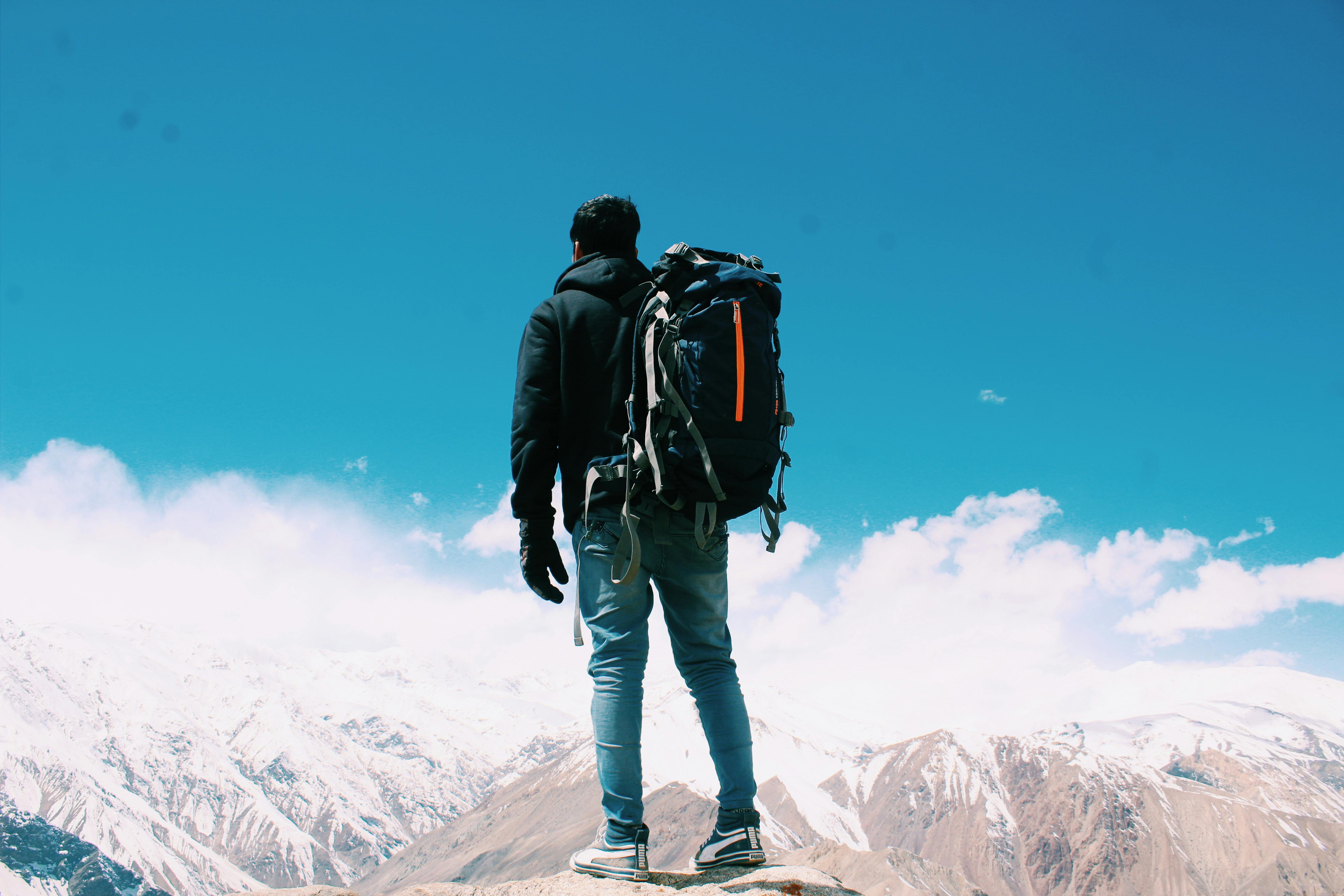 a man hiking over snowy mountains