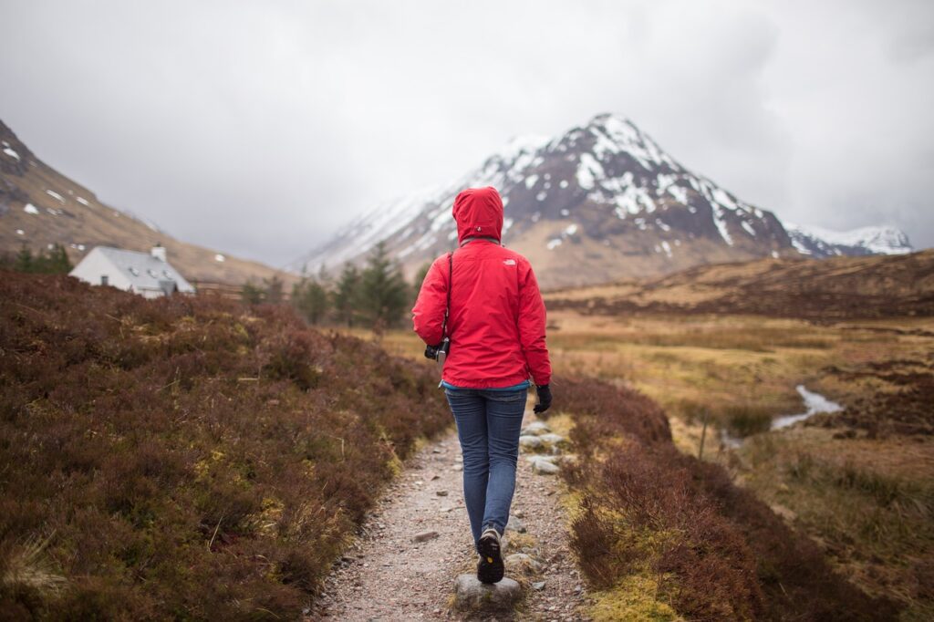 a woman hiking towards a mountain